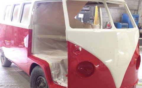 Classic camper van mid-restoration in red and white