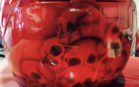 Motorcycle helmet with custom red skull airbrush design
